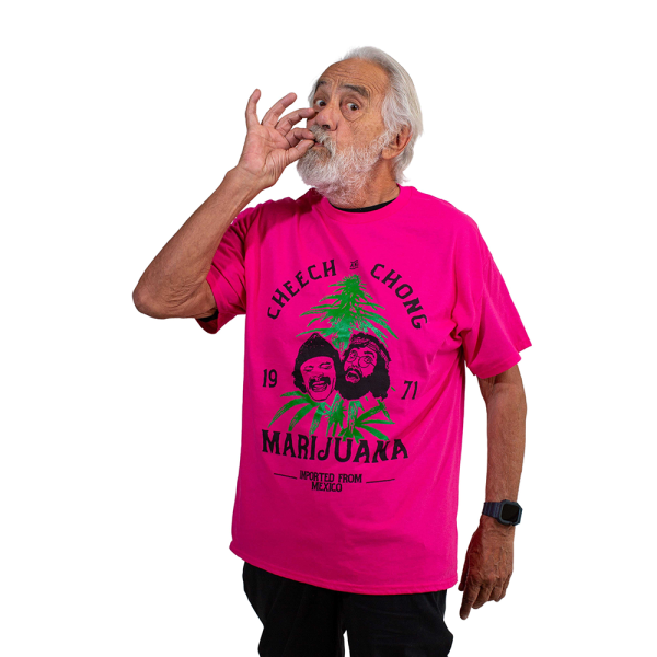 Tommy Chong poses wearing a pink shirt with Cheech and Chong written on the fron in black ink. A drawn image of Cheech and Chong in the middle.
