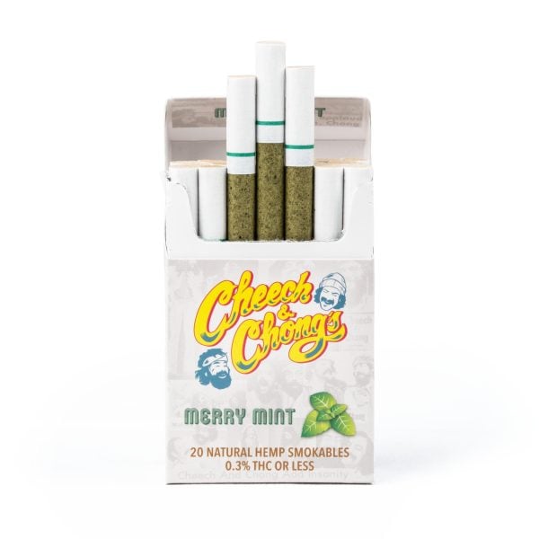 An open pack of Cheech & Chong Laser Engraved Grinder hemp cigarettes, displaying several smokables with visible green herbs, against a white background. The pack contains 20 natural hemp smokables.